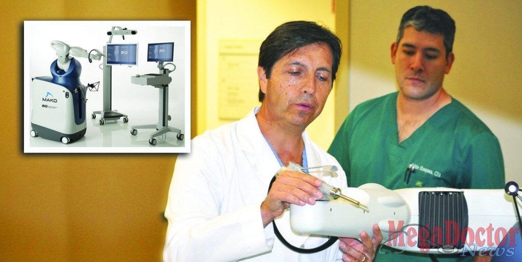 Dr. Raul Marquez, Orthopedic Surgeon demonstrates a robotic arm called “RIO® the Robot”, and to his left is Eddie Hinojosa.