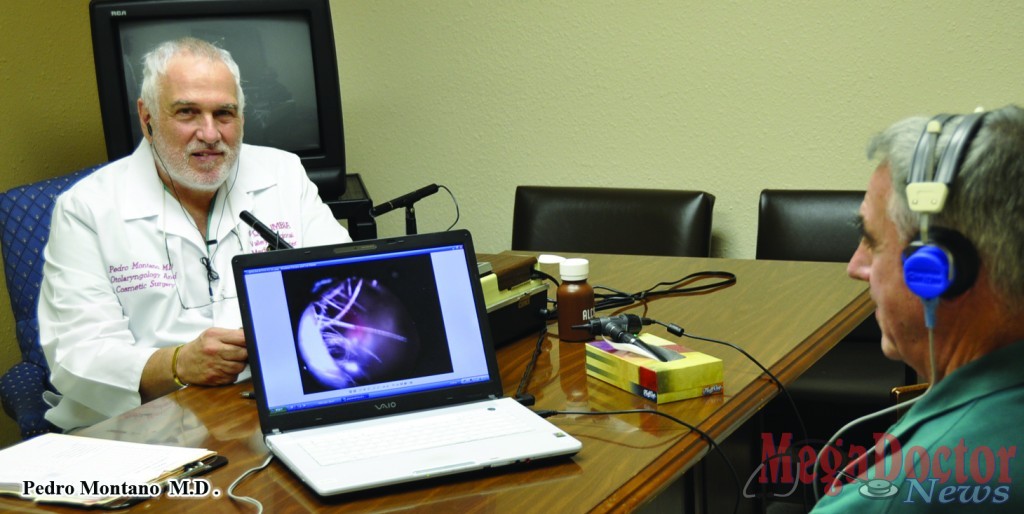 Dr. Pedro Montano as he performs a hearing test at the Las Palmas Health Care Center. Photo by Roberto Hugo Gonzalez