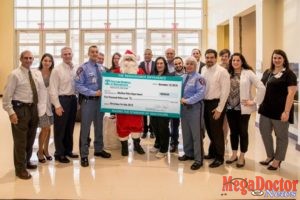 Doctors Hospital at Renaissance presents a $5,000 donation to McAllen Police Chief, Victor Rodriguez (pictured center back), and the McAllen Police Department for the 15th Annual McAllen Police Department “Christmas for Kids” toy drive and parade.