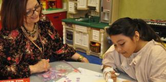 Maricela Medina, CCIS, Child Life Specialist at Valley Baptist Medical Center-Harlingen, leads 9-year-old Stephanie in an arts and crafts activity during her stay at the hospital.