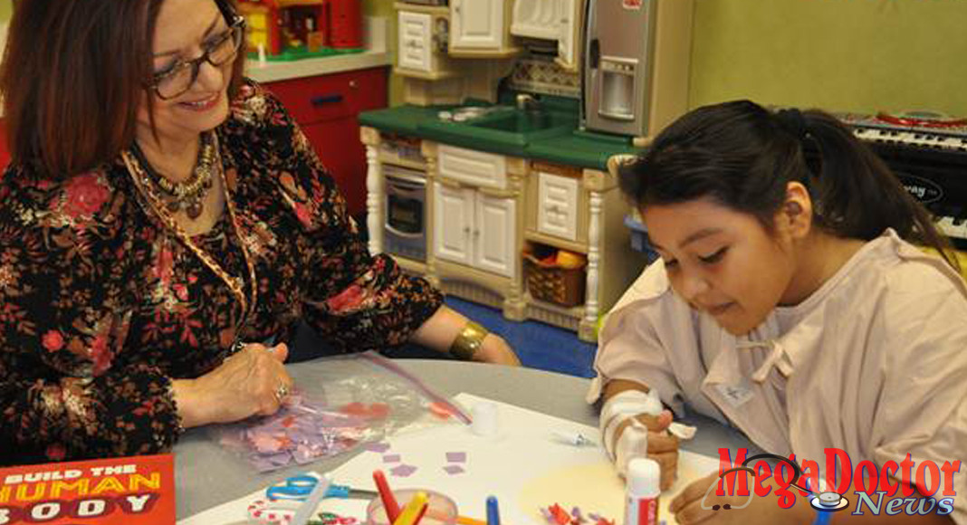 Maricela Medina, CCIS, Child Life Specialist at Valley Baptist Medical Center-Harlingen, leads 9-year-old Stephanie in an arts and crafts activity during her stay at the hospital.