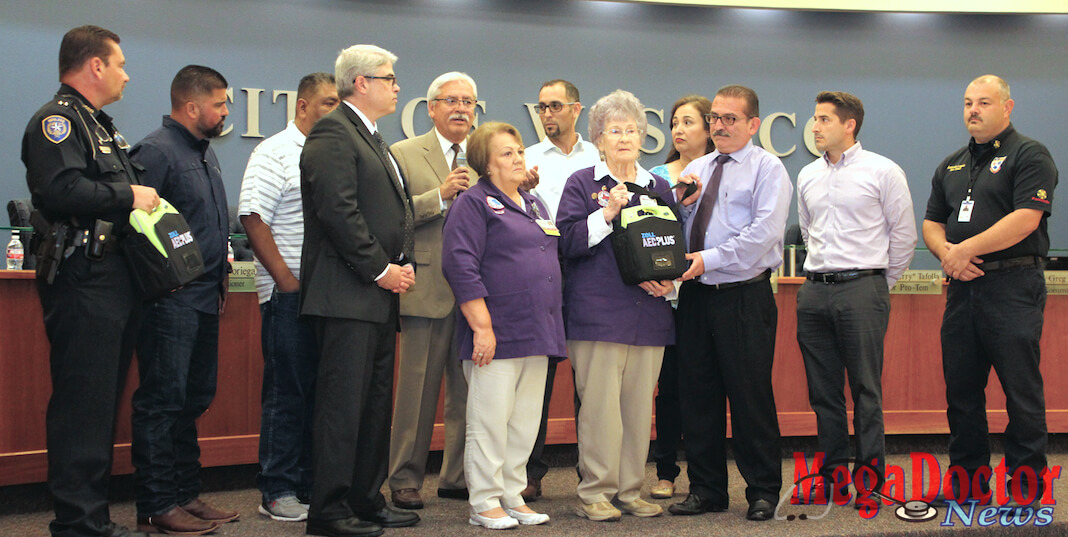 Dr. Robert Sepulveda, fifth from left, Internal Medicine Physician in Weslaco, speaks on the importance of defibrillators in helping people to survive heart attacks, while hospital volunteers with Knapp Medical Center present a donation of the life-saving devices to the City of Weslaco Police Department. From the left are Weslaco Police Chief Stephen Scot Mayer; Weslaco City Commissioner Josh Pedraza; Mayor Pro-Tem Jerry Tafolla; Rene Lopez, CEO for Knapp Medical Center; Dr. Robert Sepulveda; Anita Vallejo, Vice President for Projects for the Knapp Volunteer Auxiliary; Commissioner Leo Muñoz; Bernice Nittler, Immediate Past President of the Knapp Volunteer Auxiliary; Commissioner Letty Lopez; Weslaco Mayor David Suarez; Commissioner Greg Kerr; and Weslaco Fire Chief Antonio Lopez.