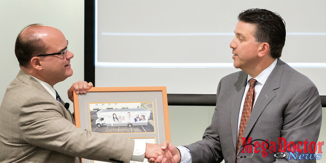 Dr. John Krouse (at left), dean of the UTRGV School of Medicine and vice president for Health Affairs, and Dave Milich, CEO of UnitedHealthcare Texas/Oklahoma, exchanged plaques during an event on Thursday, Sept. 28, 2017, at the Medical Education Building on the UTRGV Edinburg Campus. The event was to celebrate the partnership between the UTRGV School of Medicine and the United Health Foundation that helped bring about the Unimóvil mobile clinic. Mega Doctor News (UTRGV Photo by Paul Chouy)