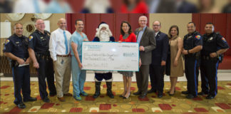DHR Health presents a $5,000 donation to Edinburg Police Chief David Edward White and the Edinburg Police Department for the 25th Annual Blue Santa Christmas Toy Drive.