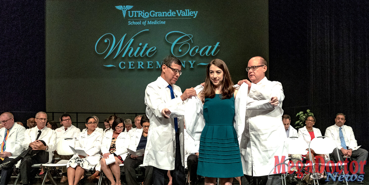 Dr. Leonel Vela and Dr. John Krouse form The University of Texas Rio Grande Valley School of Medicine welcomed its newest students with a White Coat Ceremony on Saturday, July 28, 2018, at the Performing Arts Center of the Harlingen Consolidated Independent School District. Marking the beginning of their education and career, the new medical students received their signature white lab coats from School of Medicine leaders, then recited the Hippocratic Oath – which acknowledges their primary role as caregivers – in the presence of their loved ones, school leaders, and peers. Dr. John H. Krouse, executive vice president for Health Affairs and dean of the UTRGV School of Medicine, congratulated the students for their achievements thus far and emphasized the importance of staying humble and showing compassion. (UTRGV Photo by David Pike)