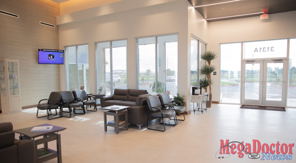 Waiting area: Energy efficient LED light fixtures illuminating exterior white wall creating contrast with black ceiling metal panels and the light coming thru the exterior glass