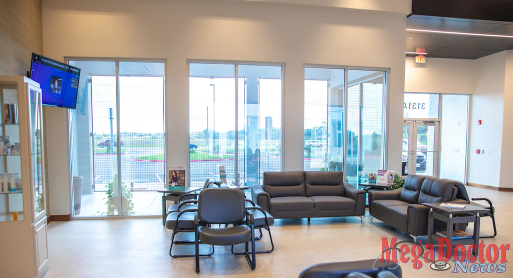 Waiting area from a different angle: High impact resistance glass storefronts that allow exterior light to enter the waiting area and create contrast with the interior finishes such as the Italian floor tile, and wall paper. 