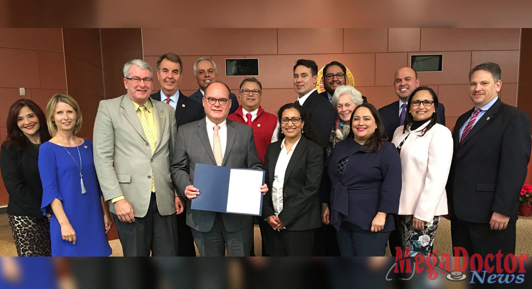 The University of Texas Rio Grande Valley on Tuesday, Dec. 11, signed a letter of intent with the Harlingen CISD to expand their partnership to create a pipeline for students enrolled at the Harlingen High School of Health Professions to the university’s Bachelor of Science in Biomedical Sciences (BMED) program and the UTRGV School of Medicine. Holding the memorandum is Dr. John H. Krouse, executive vice president for Health Affairs and dean of the UTRGV School of Medicine. (Photo Courtesy of the Harlingen CISD).