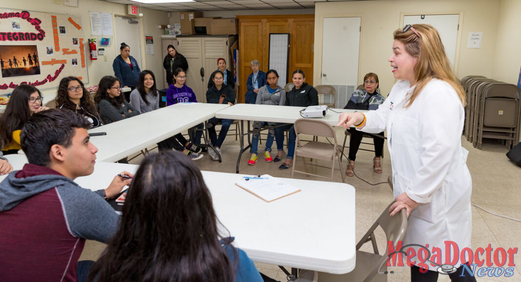 Dr. Gladys Maestre (standing, at right), a UTRGV professor of neuroscience and human genetics and director of the UTRGV Alzheimer´s Disease Resource Center for Minority Aging Research, is seen here working with a group of high school students known as the center’s Alzheimer’s Ambassadors. The center provides education, mentoring and support for the ambassadors, Maestre said, so they can go to events and into the community to become the voice of people with Alzheimer’s and their caregivers. (UTRGV Photo by David Pike)