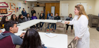 Dr. Gladys Maestre (standing, at right), a UTRGV professor of neuroscience and human genetics and director of the UTRGV Alzheimer´s Disease Resource Center for Minority Aging Research, is seen here working with a group of high school students known as the center’s Alzheimer’s Ambassadors. The center provides education, mentoring and support for the ambassadors, Maestre said, so they can go to events and into the community to become the voice of people with Alzheimer’s and their caregivers. (UTRGV Photo by David Pike)