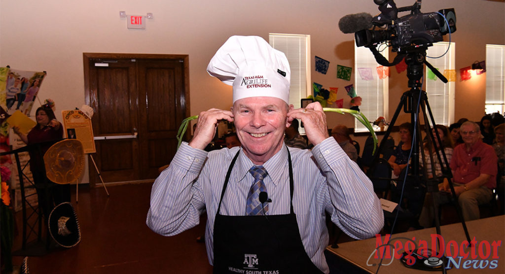 Last year, Mayor Darling hosted a dinner free and open to the community, in which he, as the chef, helped demonstrate a healthy, low-cost and culturally-relevant meal. Mayor Darling posed for Texas Border Business holding near his ears green onions to bring attention to this event and the importance of eating the right foods. Photo by Roberto Hugo Gonzalez