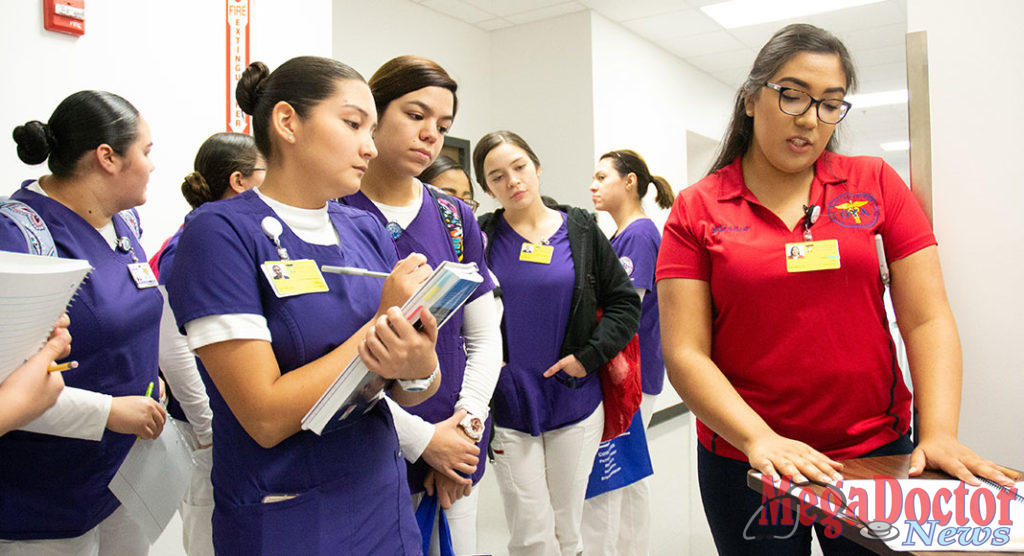 An STC student (right) pursuing an Occupational Therapy Assistant degree explains the layout inside of the Activities of Daily Living apartment to peers at STC’s Nursing and Allied Health campus. The apartment was modified to cater to patients with Alzheimer’s disease.