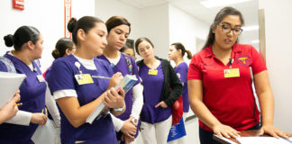 An STC student (right) pursuing an Occupational Therapy Assistant degree explains the layout inside of the Activities of Daily Living apartment to peers at STC’s Nursing and Allied Health campus. The apartment was modified to cater to patients with Alzheimer’s disease.
