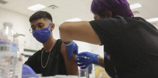 Angel Castro, 16, received his first shot of the Pfizer vaccine at William D. Slider Middle School in El Paso on July 22, 2021. After being battered by COVID-19 surges last year, El Paso has been a bright spot during the delta surge. Credit: Briana Sanchez/El Paso Times via REUTERS