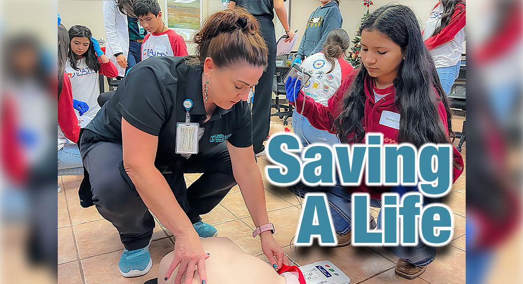 DHR Institute for Research and Development Program Manage Melissa Eddy shows Lasara ISD Middle School student how to use an AED. Courtesy Image