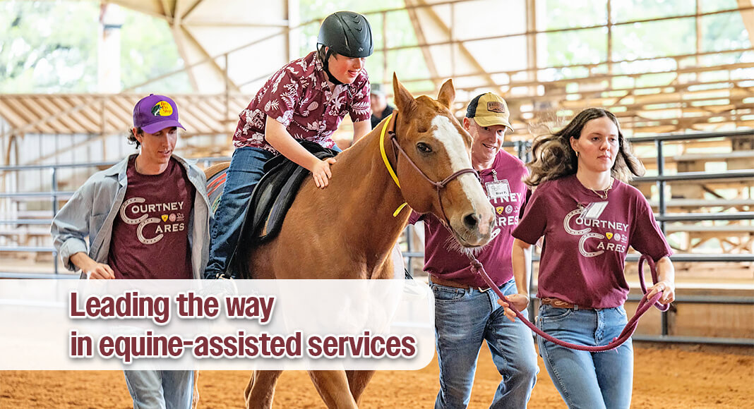 Sidewalkers and a horse handler assist a client in a trotting exercise during a Courtney Cares lesson. (Photo: Kylie Kunzler/Courtney Cares via Texas A&M AgriLiife)